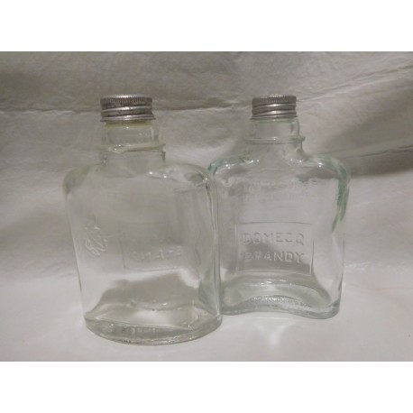 Antiguas botellas de brandy de Domecq tipo petaca con tapón metálico. Años 50.
